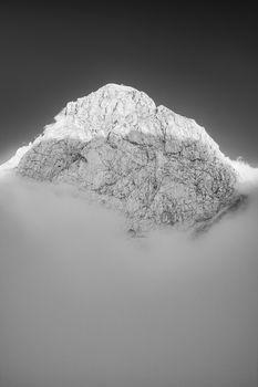 Mountain Peak Above Clouds. Black and White Monochrome Fine Art Photography.