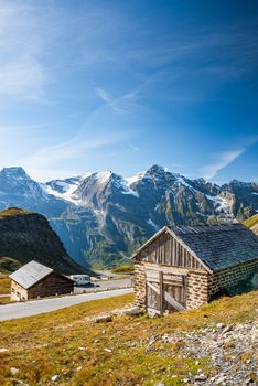 Wooden Hut at High Alpine Road with Mountains in Background, Austria.