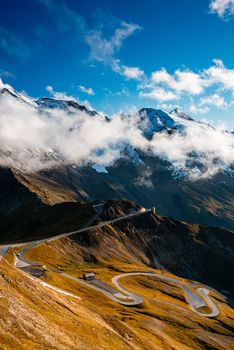 Dramatic Mountains and Clouds with Curvy Serpentine Road in Valley, Austria.