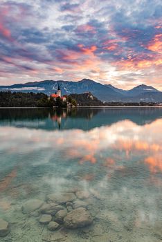 Lake Bled SLovenia and Island Church. Beautiful Sunrise and Water Reflection. Romantic Travel Destination.