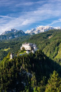 Beautiful Hohenwerfen Castle in Austria on Rocky Hill with Alps in Background.