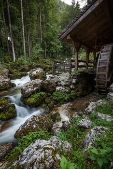 Wooden Mill at Creek by Gollinger Waterfall in Austria. Autumn Season. Long Exposure Photo.