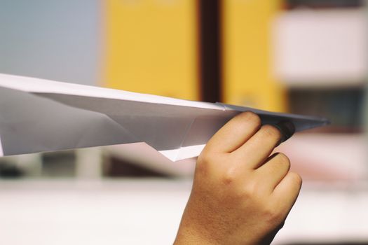 Photograph of a human hand with a paper plane
