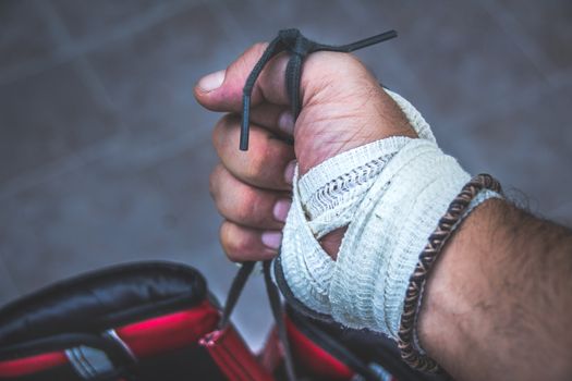 Photograph of a human fist and boxing gloves