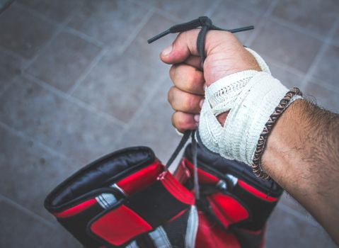 Photograph of a human fist and boxing gloves