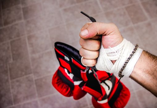 Photograph of a human fist and boxing gloves