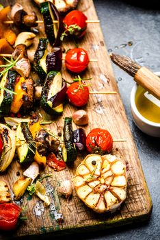 Serving Grilled BBQ Vegetables Skewers with Fresh Herbs, Marinate and Spices on Wooden Board . Summer Party Food