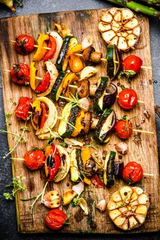 Serving Grilled BBQ Vegetables Skewers with Fresh Herbs, Marinate and Spices on Wooden Board . Summer Party Food