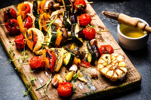 Serving Grilled BBQ Vegetables Skewers with Fresh Herbs, Marinate and Spices on Wooden Board . Summer Party Food