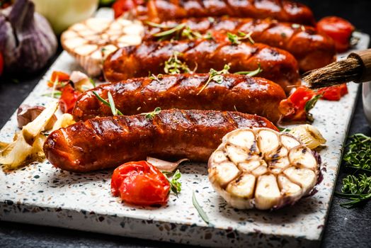 Serving Grilled Barbecue Sausage with BBQ Vegetables and Herbs.