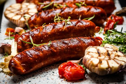 Serving Grilled Barbecue Sausage with BBQ Vegetables and Herbs.