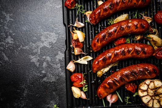 Grilled Meat Sausages with Vegetables and Herbs. BBQ Food Border Background. Top View.