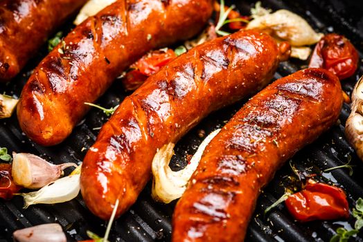 BBQ Grilled Meat Sausages with Fresh Herbs and Spices on Grill.