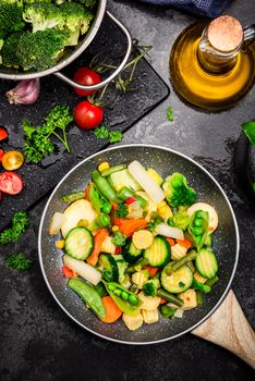 Stir Fry Vegetables on Pan. Healthy Eating and Dieting at Home. Dark Tones Image. Top Down View.