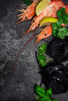 Squid Ink Black Pasta Spaghetti with Seafood and Fresh Herbs. Border Background with Copy Space. Top View.