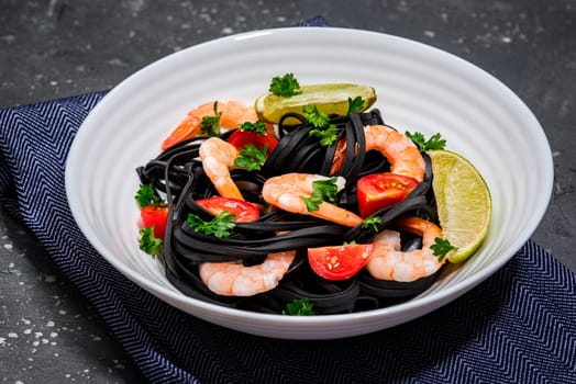 Squid Ink Pasta with Prawns , Tomatoes, Lemon and Herbs. Black Spaghetti, Black Organic Noodles . Mediterranean Gourmet Food.