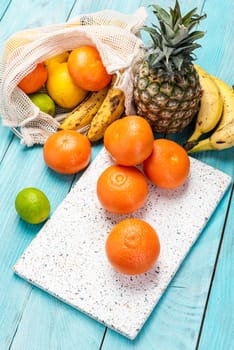 Fresh Orange and Tropical Fruits on Wooden Table. Vibrant Colors Healthy Eating.