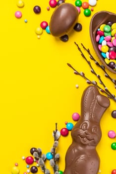 Easter Background. Chocolate Rabbit and Eggs with Colorful Candy. Copy Space on Flat Lay Design.