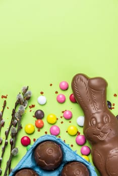 Easter Background. Festive Chocolate Egg and Rabbit. Colorful Ester Sweet Food. Copy SPace, Top View.