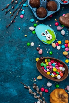 Colorful Easter Festive Background. Sweet Food Candy and Chocolate Eggs and Rabbit.
