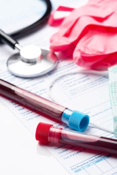 Laboratory Testing Patient’s Blood Samples for Presence of Coronavirus (COVID-19).  Test Tube Containing a Blood Sample on Doctor Table.