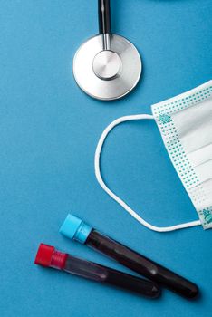 Laboratory Testing Patient’s Blood Samples for Presence of Coronavirus (COVID-19).  Test Tube Containing a Blood Sample on Doctor Table.