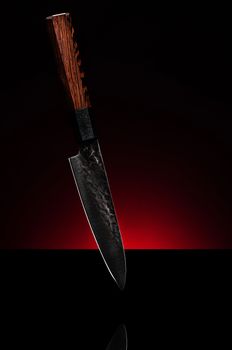 Japanese Kitchen Chef Knife on Red and Black Copy Space Background .