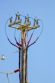 High voltage electric pole and transmission lines with clear blue sky. Electric pylon.