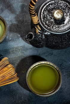 Matcha Green Tea in Bowl with Bamboo Whisk.