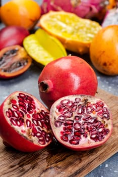 Pomegranate Tropical Fruit Cut in Half on Wooden Board.