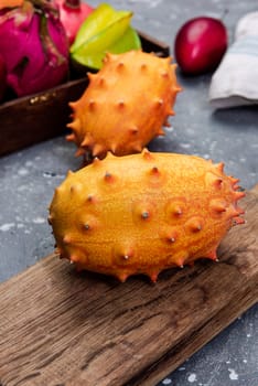 Whole Kiwano or Horned Melon Exotic Fruit on Cutting Board.