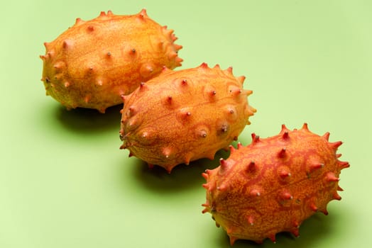 Kiwano or Horned Melon on Green Pastel Background. Exotic Fruits.