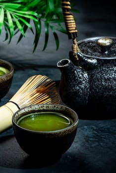 Matcha Green Tea in Bowl with Bamboo Whisk.