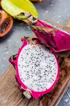 Pitahaya or Dragon Fruit Cut in Half on Board. Fresh Raw Exotic Fruits.