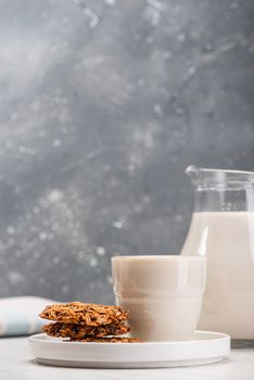 Soy or Soya Milk and Oat Cookies on Kitchen Table. Plant Based Vehan Food.