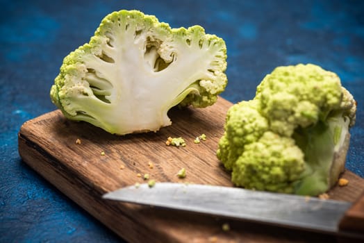 Green Cauliflower Cabbage on Cutting Board. Market Fresh Organic Food. Plant Based Diet.