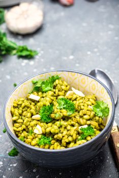 Cooking Vegetarian Plant Based Food. Buckwheat Groats with Kale, Garlic and Parsley.