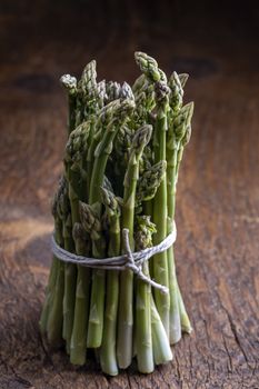 fresh green asparagus on dark wood
