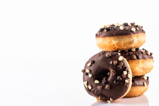 Chocolate Donut or Doughnuts on White Reflective Background with Copy Space.