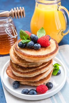 Fluffy American Pancakes with Fresh Fruits and Honey.