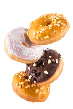 Flying Donut or Doughnut Creative Image. Falling Food On White Background. Food in Motion.