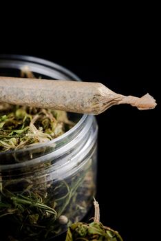 Recreational Prescription Medical Marijuana Joint and Cannabis Flower Buds in Jar.