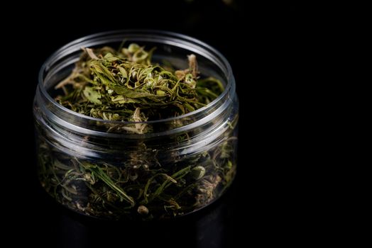 Sativa Indica or Cannabis Marijuana Flower Buds in Glass Jar. recreational Smoking Concept.