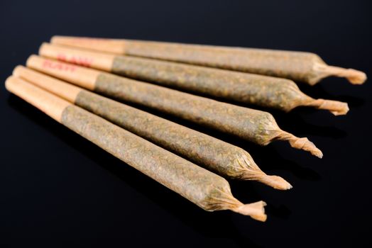 Medical Cannabis Marijuana Joints on Black Background, Close Up View.