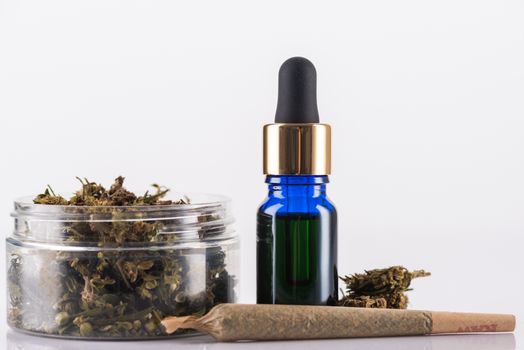Cannabidiol Oil and Cannabis Flower Buds. Medical Marijuana Conceptual Image.