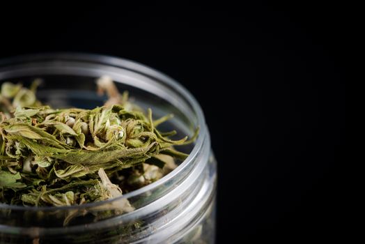 Sativa Indica or Cannabis Marijuana Flower Buds in Glass Jar. recreational Smoking Concept.