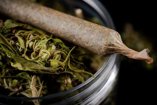 Prescription Medical Marijuana Joint and Cannabis Flower Buds in Jar. CBD and Cannabidiol Marijuana.