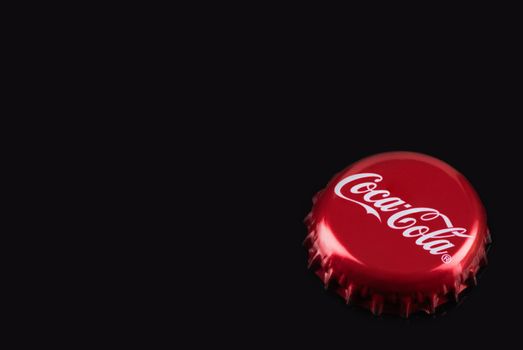 TARNOW, POLAND - FEBRUARY 01, 2020: Classic Red Coca-Cola Bottle Cap. Cocal-Cola is One of the Most Popular Refreshing Drinks.