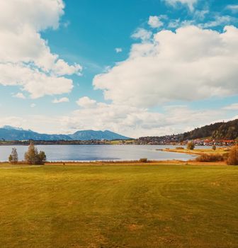 Beautiful nature of European Alps, landscape view of alpine mountains, lake and village in autumn season, travel and destination scenery