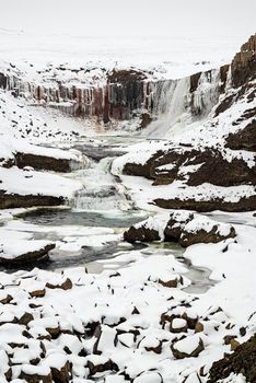 Snaedufoss waterfall during a snowing winter day, Iceland